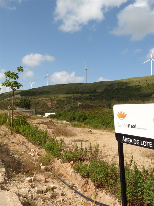 Wind turbines on hill above apartment