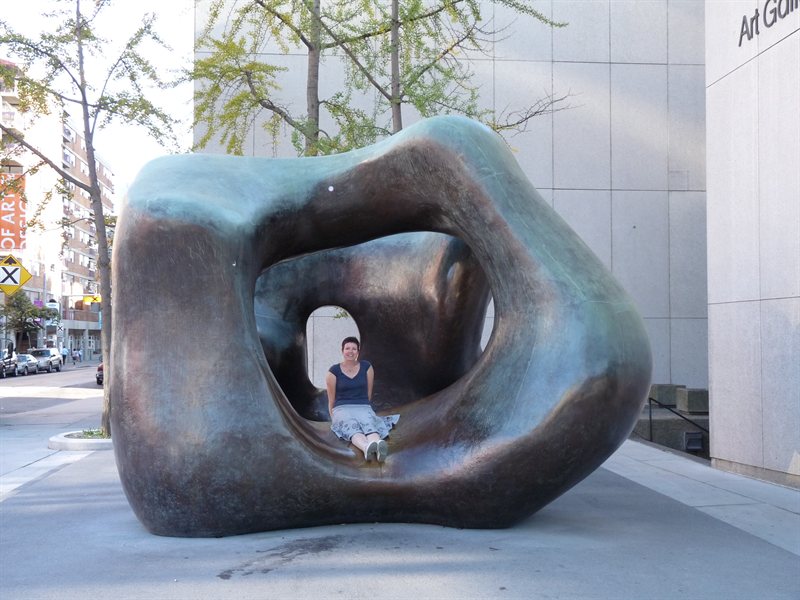 Claire sat in a Henry Moore sculpture