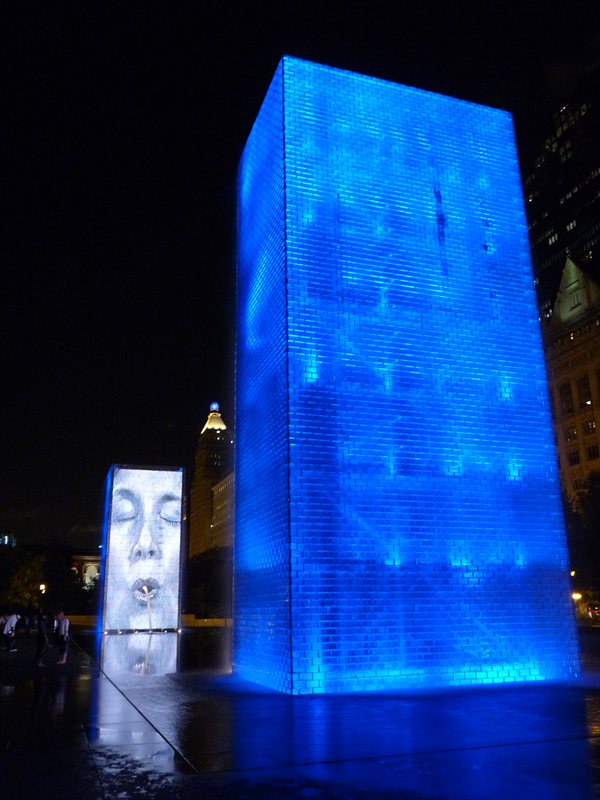 The Human Gargoyle fountain illuminated at night
