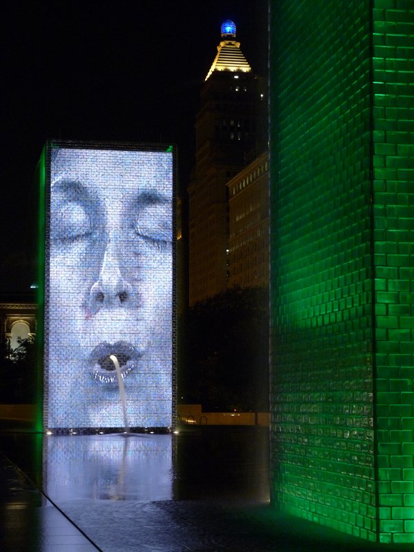 The Human Gargoyle fountain illuminated at night