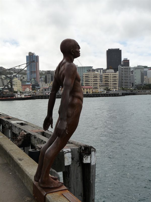 Sculpture of swimmer with Wellington city in the background