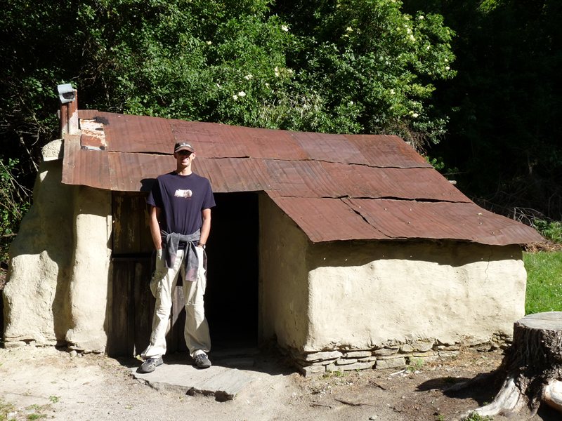 Ed outside restored Chinese hut in old Chinese settlement in Arrowtown