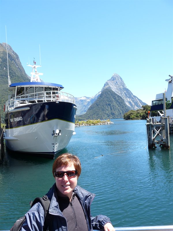 Claire with our boat and Mitre Peak at Milford Sound