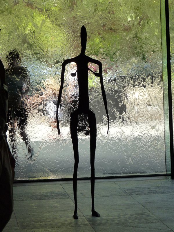 Statue in front of the waterwall at the National Gallery of Victoria