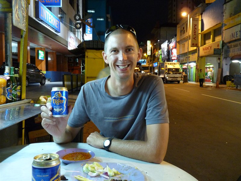 Ed with satay sticks and Tiger Beer