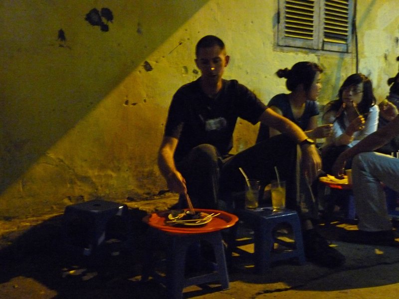 Ed enjoying satay at a street food stall