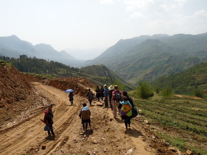 Walking to the villages, accompanied by Black H'mong  ladies