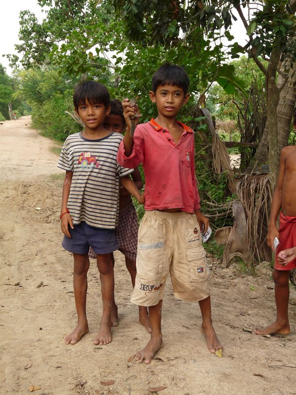 Local children with a baby squirrel